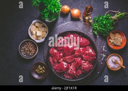 Foie de poulet cru avec des ingrédients de cuisson pour le pâté de foie, les herbes et le brandy Banque D'Images