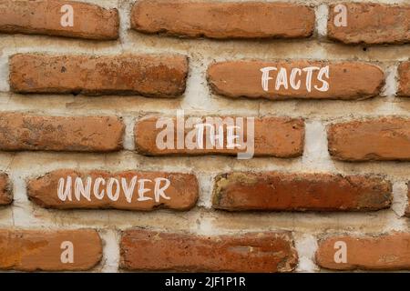 Uncover the facts symbol. Concept words Uncover the facts on red bricks on a beautiful brick wall background. Business and uncover the facts concept. Banque D'Images