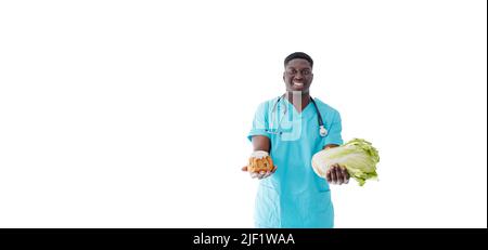 Un médecin afro-américain sur fond blanc avec des bonbons verts entre ses mains. Banque D'Images