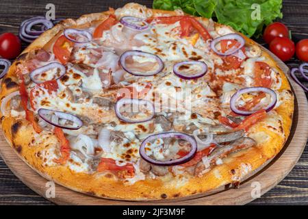 Pizza avec bacon et fromage, herbes et tomates cerises. Avec mozzarella, crevettes et pieuvres, moules et autres produits sur fond de bois. cop Banque D'Images