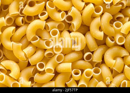 Dry Elbow Pasta Macaroni Noodles fond de pile. Banque D'Images