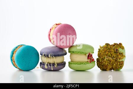 gâteaux français ronds à base de macarons à la farine d'amandes sur fond blanc.Arôme framboise, pistache et lavande Banque D'Images