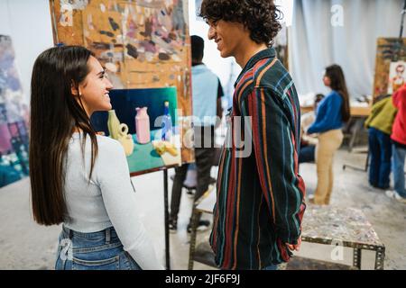 Les jeunes étudiants peignent à l'intérieur de la classe d'art en salle à l'université - Focus sur le visage de fille Banque D'Images