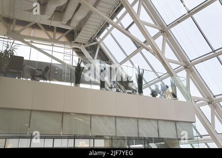 Intérieur moderne d'un immeuble de bureaux. L'intérieur d'un centre d'affaires moderne de plusieurs étages avec de grandes fenêtres et de nombreux bureaux en face d'eux. Plantes vertes en pots. Photo de haute qualité Banque D'Images