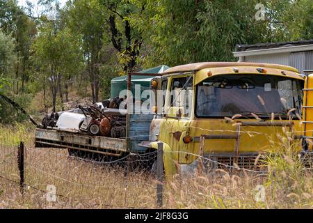 Un vieux camion jaune plein d'équipements miniers de saphir rouillé sur des champs de gemmes à Rubyvale Queensland en Australie Banque D'Images