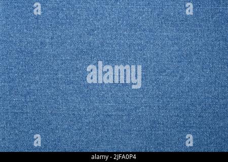 Arrière-plan en tissu texturé. Une texture jean ou denim en bleu clair. Banque D'Images
