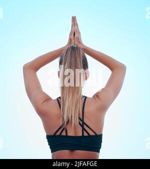 Vision belle femme pratiquant l'exercice de yoga sur la plage. Jeune athlète féminine s'étirant en s'étirant à l'extérieur. Trouver la paix intérieure et Banque D'Images