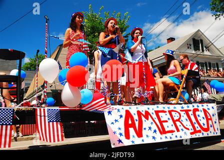 Un trio de jeunes filles interprète une sélection de chansons patriotiques sur une scène lors d'une parade du 4 juillet à Bristol, Rhode Island Banque D'Images