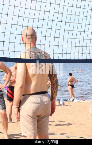 Photographie de personnes jouant au volley-ball de plage en été Banque D'Images