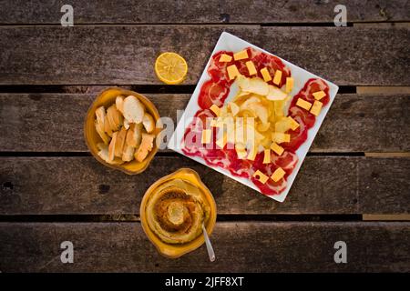 Jambon fumé, fromage, pain et houmous. Hors-d'œuvre méditerranéen traditionnel. Vue de dessus vers le bas. Banque D'Images