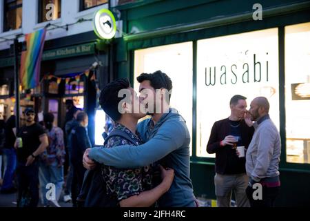 Une paire de couples gays est vue embrasser passionnément à Soho. Le 50th anniversaire de la célébration de la fierté de Londres se poursuit à Soho, dans le centre de Londres, après la fin du défilé de la fierté à Whitehall dans l'après-midi. Banque D'Images