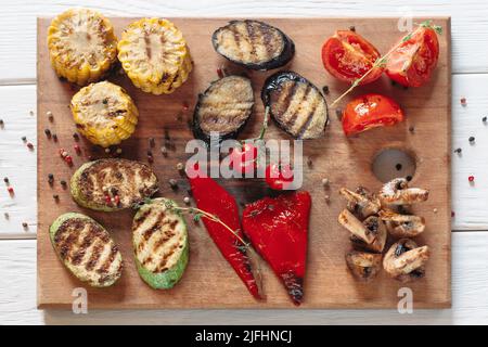 Légumes grillés sur planche à découper en bois Banque D'Images