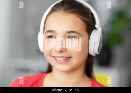 Girl in headphones listening to music at home Banque D'Images