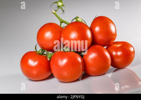 Tomates coupées tomates sur la vigne - tomate mûre rouge - tomates fond blanc découpe tomatos Solanum lycopersicum Banque D'Images