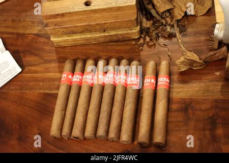 Un gros plan de cigares roulés faits à la main sur une table en bois Banque D'Images
