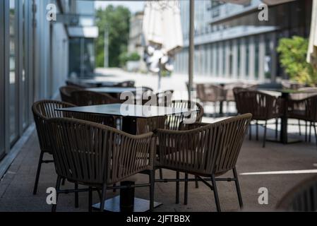 Des tables et des chaises de bar à café sont installées dans les rues de la ville Banque D'Images