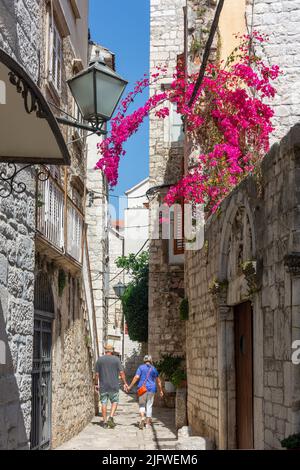 Couple marchant dans la rue, la vieille ville, Trogir, Split-Dalmatie Comté, Croatie Banque D'Images