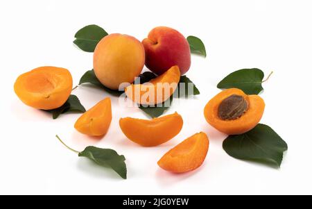 Abricots savoureux. Fruits frais abricot isolés sur fond clair, tranchés et entiers. Vue rapprochée. Banque D'Images