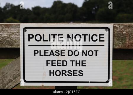 Panneau sur une porte de ferme disant poli avis s'il vous plaît ne pas nourrir les chevaux Banque D'Images