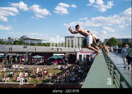 03.07.2022, Berlin, Allemagne, Europe - deux jeunes hommes sautent du pont Gustav-Heinemann dans la rivière Spree, lors d'une chaude journée d'été. Banque D'Images