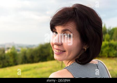 Portrait en gros plan femme de 40-44 ans avec de courts cheveux noirs. Banque D'Images