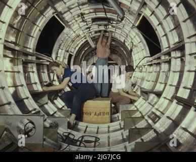 Les travailleuses installent des accessoires et des assemblages sur une section de fuselage de queue d'un bombardier B-17 à l'usine de Douglas Aircraft Company, à long Beach, en Californie, mieux connue sous le nom de « Forteresse volante », le B-17F est un modèle plus récent du B-17, Qui se distingue dans l'action dans le Pacifique Sud, en Allemagne et ailleurs. C'est un bombardier lourd à longue portée, à haute altitude, avec un équipage de sept à neuf hommes et un armement suffisant pour se défendre sur les missions de la lumière du jour. Banque D'Images