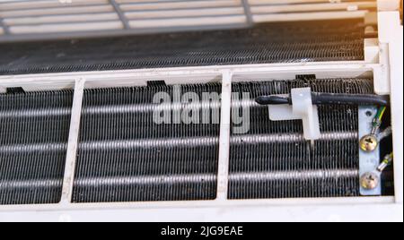 Un homme désassemble un climatiseur pour le nettoyage. Maintenance du système divisé. Banque D'Images