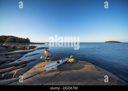 Déballage du kayak sur l'île de Lanskeri, Hamina, Finlande Banque D'Images