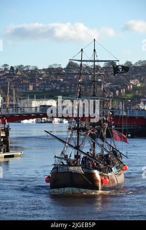 Bateau pirate quittant le port de Whitby par Une journée ensoleillée - Whitby Swing Bridge in the Background - River Esk - North Yorkshire - Royaume-Uni Banque D'Images