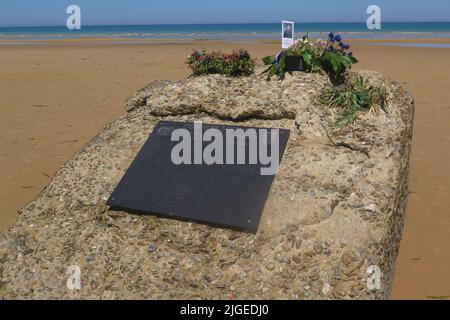 Des fleurs et une photo sur une pierre commémorative commémorent Edward Morozewicz, médique, tué à Omaha Beach le 6 juin 1944, à l'âge de 22 ans, Arromanches-les-bains, FRA Banque D'Images