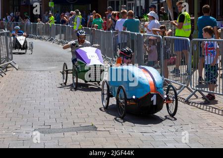 Ringwood, Hampshire, Royaume-Uni. 10th juillet 2022. Le Grand Prix de la voiture à pédales britannique a eu lieu pour la première fois dans la ville de Ringwood en 1987. L'événement attire désormais des milliers de spectateurs chaque année pour observer les « voitures » lorsqu'elles tournent autour de la piste en ville. Les foules affluent pour voir l'excitation par une chaude journée ensoleillée. Crédit : Carolyn Jenkins/Alay Live News Banque D'Images