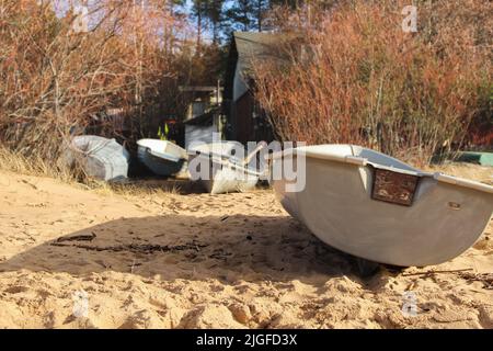 Bateaux de pêche qui sont tirés à terre. Petits bateaux devant le cottage des pêcheurs. La vie sur la plage est capturée lors de la promenade en plein air. Banque D'Images