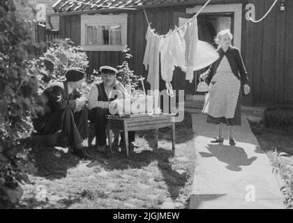 Stadsdel Prince Wilhelm visite du cottage 'Vega-Sven' sur Västerudd. Vega-Sven a vendu le chalet au chantier naval en 1913. Le chantier naval à son tour a loué le cottage. La photo a été prise lors de la visite du prince Wilhelm à la famille Hansson dans le cadre du film « autour d'une ville de guerre » qui a été créé en 1937. Sur la photo le prince Wilhelm, Karl August Hansson (1863-1949), qui est basé sur un modèle de Jarramas et de sa femme Johanna Gustava née Johansson (1866-1939), qui vient avec le café. La photo a probablement été prise en 1935 Banque D'Images