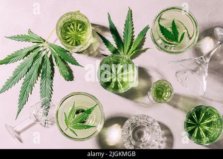 SBD chanvre boisson dans divers verres, fond béton clair ombre dure, l'énergie cocktail cannabis Banque D'Images