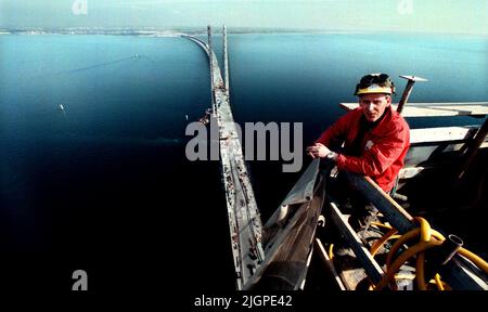 Un ouvrier de la construction regarde de la vue d'un des pylônes du pont Öresund. En arrière-plan se trouve la ville de Malmö. Banque D'Images