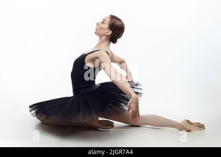 la ballerine élégante a fait un fléchissement. photo dans le studio sur un fond blanc. Banque D'Images