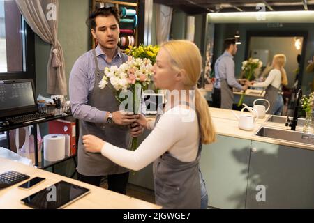 Deux fleuristes au travail dans un fleuriste Banque D'Images