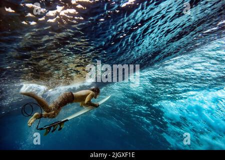 Vue sous-marine du surfeur mâle faisant de la plongée de canard Banque D'Images