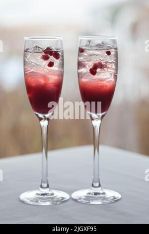 Deux cocktails de canneberges et de grenade dans des verres à champagne Banque D'Images