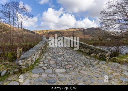 New Bridge, le pont de catégorie 2 au-dessus de la rivière Derwent, dans la vallée de Borrowdale, dans le parc national de Lake District, Cumbria, Angleterre. Banque D'Images