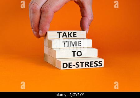 Prenez le temps de déstresser le symbole. Les mots de concept prennent le temps de déstresser sur les blocs de bois. Belle table orange fond orange. Affaires psychologiques Banque D'Images