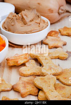 biscuits biologiques faits maison pour chiens et ingrédients sur bois brut avec espace de copie Banque D'Images