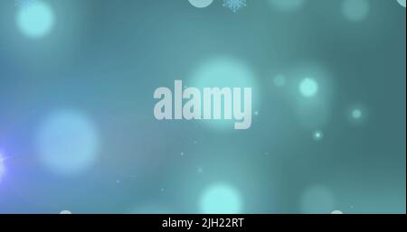 Image des taches lumineuses et de la neige tombant sur fond vert Banque D'Images