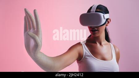 Femme se transformant en avatar 3D dans le métaverse. Une gameuse féminine entre dans un jeu tout en portant des lunettes de réalité virtuelle. Jeune femme qui vit imm Banque D'Images