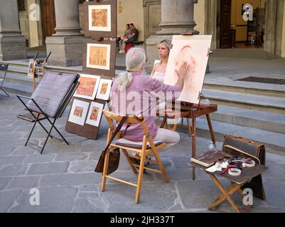 Peintre de portrait de rue à l'extérieur de la Galerie des Offices Florence Italie Banque D'Images