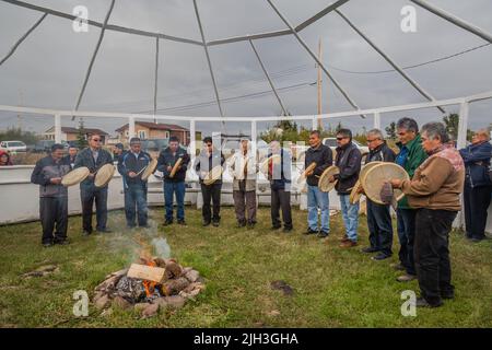 Des Dénés autochtones avec des tambours traditionnels effectuant une cérémonie d'alimentation au feu, dans la communauté nord de Deline, Territoires du Nord-Ouest, Canada Banque D'Images