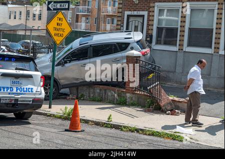 New York, États-Unis. 14th juillet 2022. NEW YORK, NEW YORK – LE 14 JUILLET : des policiers du département de police de New York (NYPD) ont fait des enquêtes sur les dégâts après qu'une voiture ait été incontrôlée et qu'elle a fait un accident dans une maison du quartier d'Astoria, à 14 juillet 2022, dans la ville de New York. Le conducteur a perdu le contrôle de sa voiture, vers 7 le matin, en faisant un demi-tour et un accident à travers une clôture de maison et un patio. Le conducteur n'a pas été blessé dans l'accident. Crédit : Ron Adar/Alay Live News Banque D'Images