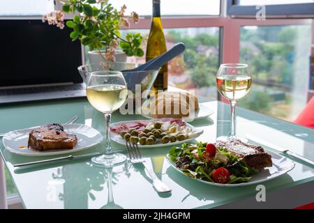 Dîner romantique table, verres à vin et salade de tomates, accueil date de Banque D'Images