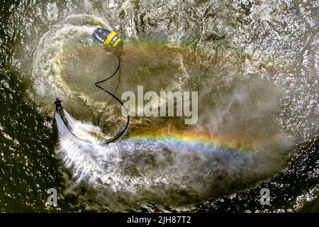 Les couleurs arc-en-ciel sont formées par un jet d'un spectacle acrobatique de flyboarding pendant le Bristol Harbour Festival à Bristol. Date de la photo: Samedi 16 juillet 2022. Banque D'Images