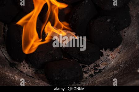 Allumer un feu de barbecue. Briquette et briquette blanche. Flamme au charbon de bois. Banque D'Images